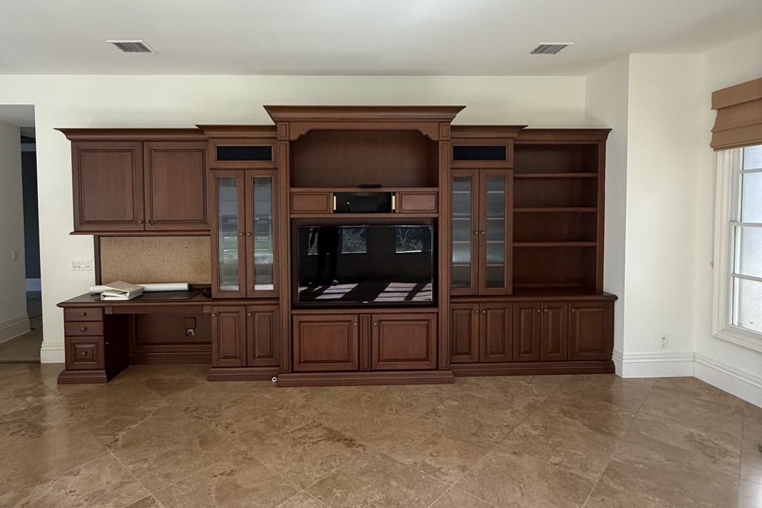 Entertainment wall before remodel, dark wood built-ins
