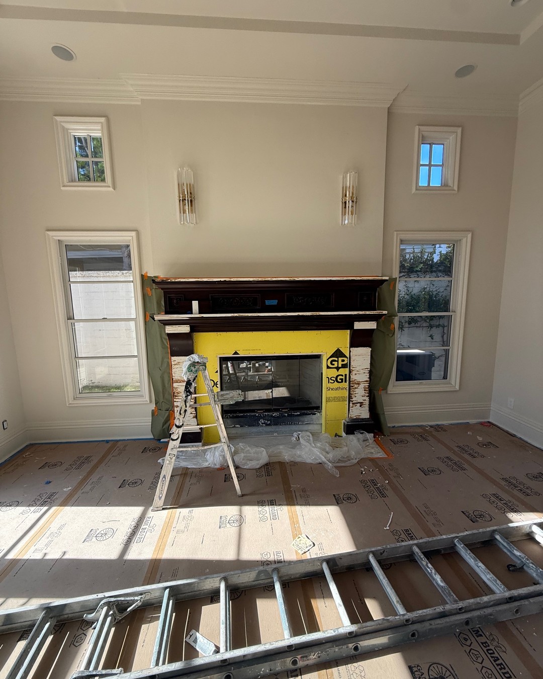 Fireplace during remodel, mantel masked with sheathing around the firebox